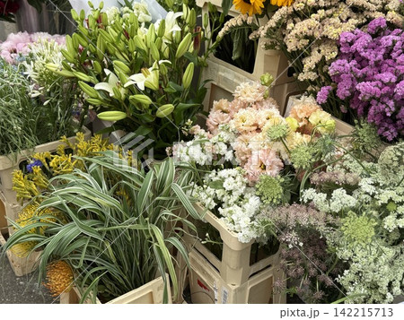 Colorful assortment of various fresh flowers in crates at a market stall for sale Colorful assortment of various fresh flowers in crates at a market stall for sale 142215713