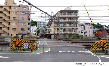 Japanese Railway Crossing with Tracks, Warning Signals and Urban Buildings Japanese Railway Crossing with Tracks, Warning Signals and Urban Buildings 142215749