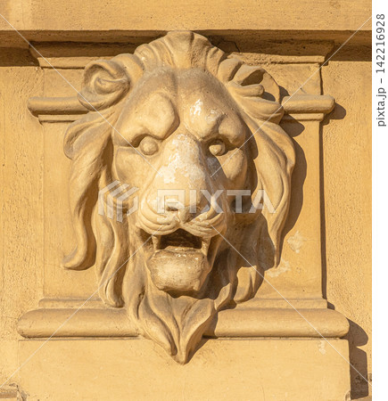 Lion head relief carving on building wall Lion head relief carving on building wall 142216928