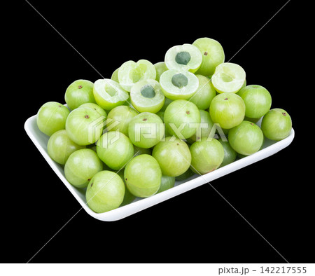 Indian gooseberry fruits or Amla berry ( phyllanthus emblica ) in plate on back background. Indian gooseberry fruits or Amla berry ( phyllanthus emblica ) in plate on back background. 142217555