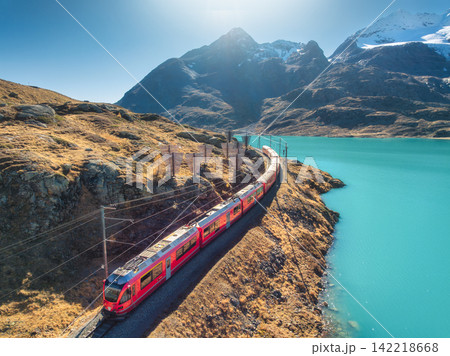 Aerial view of red Bernina Express train near turquoise lake 142218668