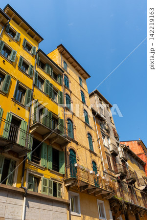 Historic Yellow Facades with Green Wooden Shutters in Piazza delle Erbe in Verona City Center Italy Historic Yellow Facades with Green Wooden Shutters in Piazza delle Erbe in Verona City Center Italy 142219163