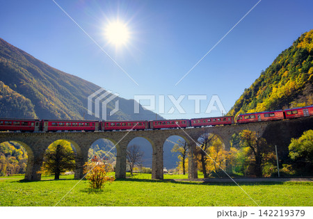 Bernina Express red train on Brusio spiral viaduct in autumn 142219379
