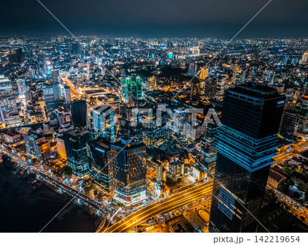 night view of illuminated Ho Chi Minh city skyline and Saigon river, neon street lights of financial downtown district with tall skyscraper towers, Vietnam aerial drone view 142219654