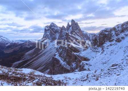 Snow-covered peaks of Seceda beneath dramatic clouds 142219740