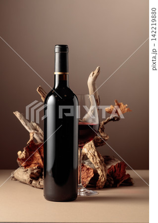 Bottle of red wine with a composition of old wood. Bottle of red wine with a composition of old wood. 142219880
