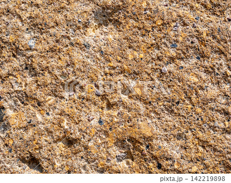 old wall from orange armenian tuff stone close-up 142219898