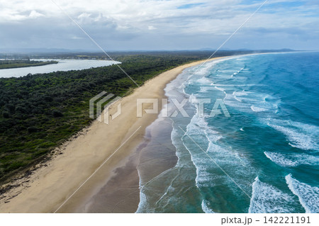 Aerial view of the Hastings River and Pacific Ocean separated by a strip of green coastal landscape, looking towards Point Plomer in the distance near Port Macquarie on the Mid North Coast of NSW, Aerial view of the Hastings River and Pacific Ocean separated by a strip of green coastal landscape, looking towards Point Plomer in the distance near Port Macquarie on the Mid North Coast of NSW, 142221191