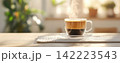 Freshly Brewed Coffee in Transparent Glass Mug on Wooden Table 142223543