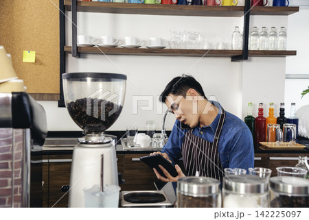 Portrait barista Asian man coffee shop owner smiling look at camera small business confident person Entrepreneur manager professional men standing coffee counter bar. Barista small business Owner Portrait barista Asian man coffee shop owner smiling look at camera small business confident person Entrepreneur manager professional men standing coffee counter bar. Barista small business Owner 142225097