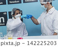 Two caucasian scientist men woman fist bump team partner shake hands together. Teamwork two scientist science chemistry research in laboratory. Close up hands pharmaceutical science team partnership 142225203