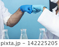 Two caucasian scientist men woman fist bump team partner shake hands together. Teamwork two scientist science chemistry research in laboratory. Close up hands pharmaceutical science team partnership 142225205