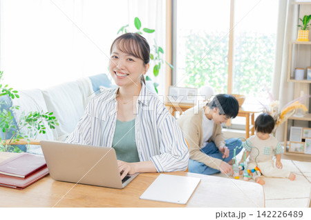 育児しながらテレワークする母親 育児しながらテレワークする母親 142226489