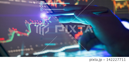 Trading strategy and financial plan concept. Trader hand using stylus to mark digital checklist over stock market candlestick charts. Trading strategy and financial plan concept. Trader hand using stylus to mark digital checklist over stock market candlestick charts. 142227711