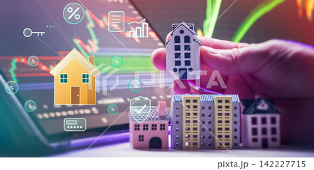 Property technology and smart real estate concept. Digital housing interface with security, loan, and interest rate holograms over laptop screen. 142227715
