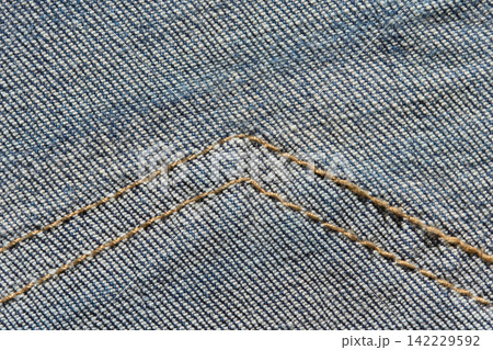 Light Blue Denim Fabric With Double Golden Seam Stitching Forming Angled Lines Across Frame Light Blue Denim Fabric With Double Golden Seam Stitching Forming Angled Lines Across Frame 142229592
