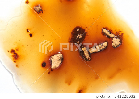 Brown Sauce Spill Crumbs White Surface Close-Up Concentrated Pooling With Visible Spice Fragments Brown Sauce Spill Crumbs White Surface Close-Up Concentrated Pooling With Visible Spice Fragments 142229932
