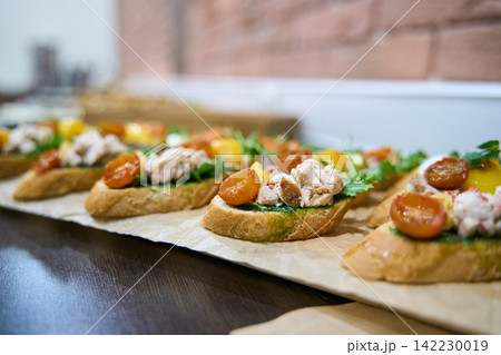 Open Faced Baguette Toasts Topped With Crab Salad Roasted Cherry Tomatoes And Greens Arranged Open Faced Baguette Toasts Topped With Crab Salad Roasted Cherry Tomatoes And Greens Arranged 142230019