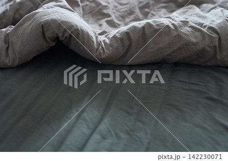 Duvet Partially Folded Bedroom Closeup Linen Sheet On Bed With Charcoal Fitted Sheet And Visible Duvet Partially Folded Bedroom Closeup Linen Sheet On Bed With Charcoal Fitted Sheet And Visible 142230071