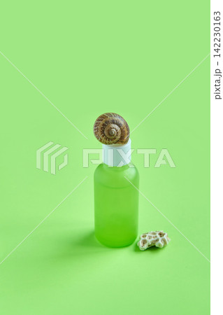 Green Frosted Dropper Bottle Topped By Snail Shell With Small Shell Fragment Beside On Monochrome 142230163