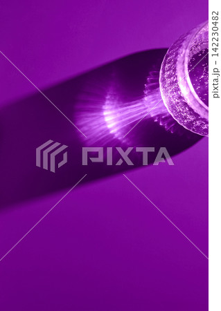 Glass Bottle Casting Radial Light Pattern On Magenta Background In Closeup Shadow Study Glass Bottle Casting Radial Light Pattern On Magenta Background In Closeup Shadow Study 142230482