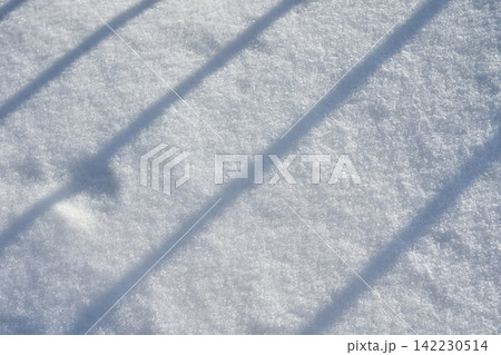 Diagonal Railing Shadows Crossing Fresh Snow Surface In Outdoor Winter Scene With Granular Diagonal Railing Shadows Crossing Fresh Snow Surface In Outdoor Winter Scene With Granular 142230514