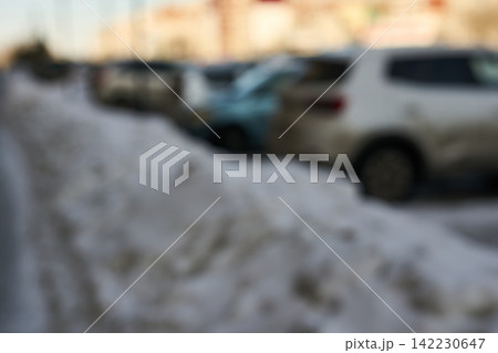 Snowbank Lining Sidewalk With Parked Cars Blurred In Residential Street During Winter Morning Urban Snowbank Lining Sidewalk With Parked Cars Blurred In Residential Street During Winter Morning Urban 142230647
