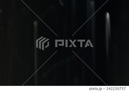 Vertical White Light Columns Descending And Fading Against Deep Black Background In Dark Low Light Vertical White Light Columns Descending And Fading Against Deep Black Background In Dark Low Light 142230757
