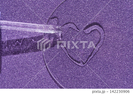 Glass Dropper Creating Heart Shaped Liquid Line On Glitter Textured Purple Surface Under Studio Glass Dropper Creating Heart Shaped Liquid Line On Glitter Textured Purple Surface Under Studio 142230906