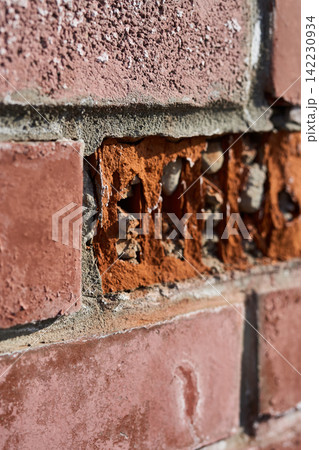 Brick Wall Showing Eroded Mortar And Exposed Aggregate In Vertical Closeup Of Damaged Red Masonry Brick Wall Showing Eroded Mortar And Exposed Aggregate In Vertical Closeup Of Damaged Red Masonry 142230934