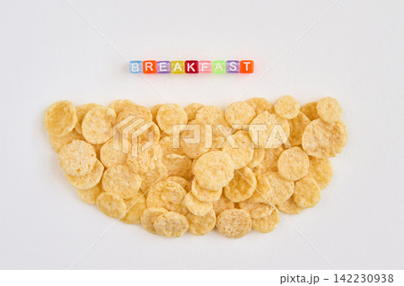 Cornflake Pile Forming Semicircle With Multicolored Block Letters Spelling Breakfast Above On White Cornflake Pile Forming Semicircle With Multicolored Block Letters Spelling Breakfast Above On White 142230938
