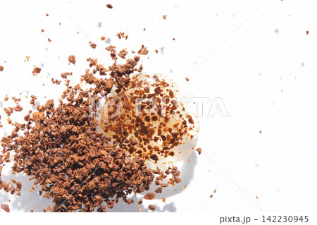 Instant Coffee Granules Scattering Around Cream Dollop On White Background In Studio Highkey Instant Coffee Granules Scattering Around Cream Dollop On White Background In Studio Highkey 142230945