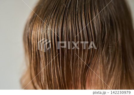 Detail Of Wet Brown Hair Draped Over Forehead Showing Fine Strand Texture And Scalp Contrast Detail Of Wet Brown Hair Draped Over Forehead Showing Fine Strand Texture And Scalp Contrast 142230979