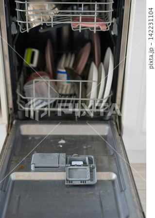 Dishwasher Door Lowered With Visible Detergent Compartment And Loaded Lower Rack Containing Plates Dishwasher Door Lowered With Visible Detergent Compartment And Loaded Lower Rack Containing Plates 142231104