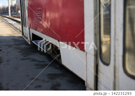 Tram Carriage Parked Showing Lower Side Panel And Exposed Wheel Well At Outdoor Station Platform Tram Carriage Parked Showing Lower Side Panel And Exposed Wheel Well At Outdoor Station Platform 142231293