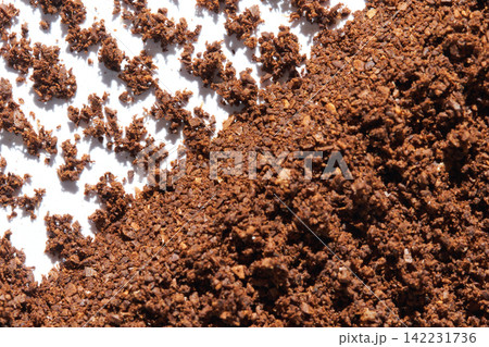 Coffee Grounds Piled Along Diagonal Edge On White Background Macro View Highlighting Crumbly Brown Coffee Grounds Piled Along Diagonal Edge On White Background Macro View Highlighting Crumbly Brown 142231736