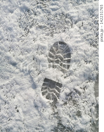 Single Boot Print In Fresh Snow On Pavement Creating Defined Tread Imprint And Icy Textured Surface 142231765