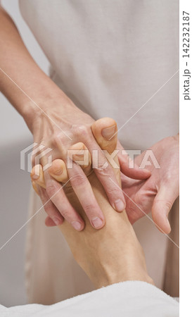 Therapist Performing Foot Massage Holding Patient Foot Illustrating Healthcare Treatment Therapist Performing Foot Massage Holding Patient Foot Illustrating Healthcare Treatment 142232187
