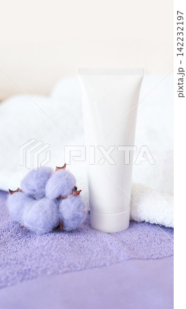 Blank Skincare Tube Positioned Beside Lavender Cotton Bolls On Textured Towel In Bright Minimalist Blank Skincare Tube Positioned Beside Lavender Cotton Bolls On Textured Towel In Bright Minimalist 142232197