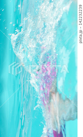 Water Cascade Splashing Along Turquoise Pool Wall With Flowing Bubbles And Blurred Swimmer Motion Water Cascade Splashing Along Turquoise Pool Wall With Flowing Bubbles And Blurred Swimmer Motion 142232239