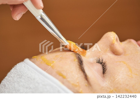 Young Female Asian Enjoying A Relaxing Facial Mask Treatment At A Spa For Skin Rejuvenation Young Female Asian Enjoying A Relaxing Facial Mask Treatment At A Spa For Skin Rejuvenation 142232440