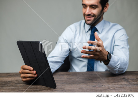 Man smiles while holding a tablet6 | 33 Man smiles while holding a tablet6 | 33 142232976