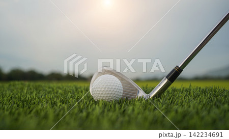 Golf clubs and balls on a green lawn in a beautiful golf course with morning sunshine. 142234691
