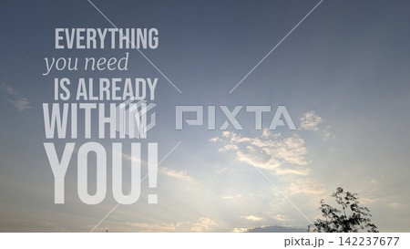 A vertical composition shows soft blue sky filled with bright dusk clouds glowing above tree silhouetted leaves. Overlaid motivational wisdom typography text states "EVERYTHING you need IS ALREADY A vertical composition shows soft blue sky filled with bright dusk clouds glowing above tree silhouetted leaves. Overlaid motivational wisdom typography text states "EVERYTHING you need IS ALREADY 142237677