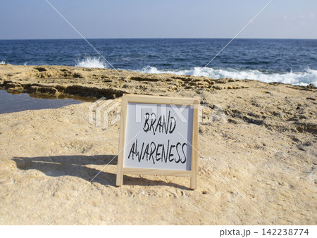 Brand Awareness symbol. White blackboard with Concept words Brand Awareness. Beautiful sea background. Business and Brand Awareness concept. Copy space. 142238774