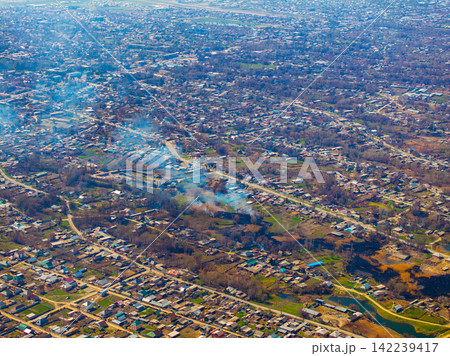 Aerial View of Residential Settlement with Smoke Plumes Aerial View of Residential Settlement with Smoke Plumes 142239417