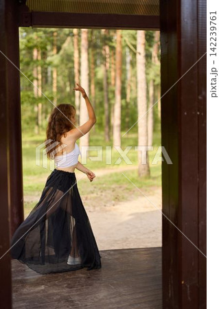 Caucasian lady moving dynamically among trees with cheerful energy Caucasian lady moving dynamically among trees with cheerful energy 142239761