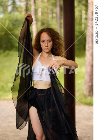 Editorial portrait with sheer scarf and confident pose Editorial portrait with sheer scarf and confident pose 142239767