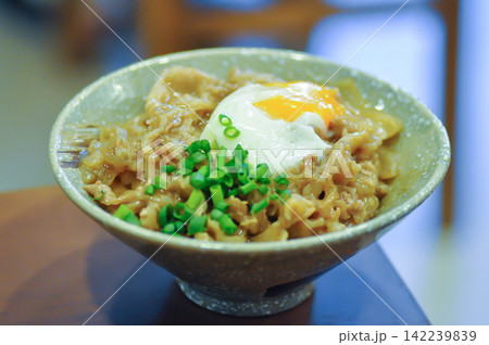 Rice topped with stir fried pork or stir fried beef and egg or Japanese food or Korean food or Beef Rice Bowl , Gyudon Rice topped with stir fried pork or stir fried beef and egg or Japanese food or Korean food or Beef Rice Bowl , Gyudon 142239839