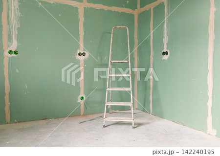 Empty unfinished interior with renovation equipment and copy space Empty unfinished interior with renovation equipment and copy space 142240195